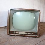 vintage brown crt tv on parquet wood flooring